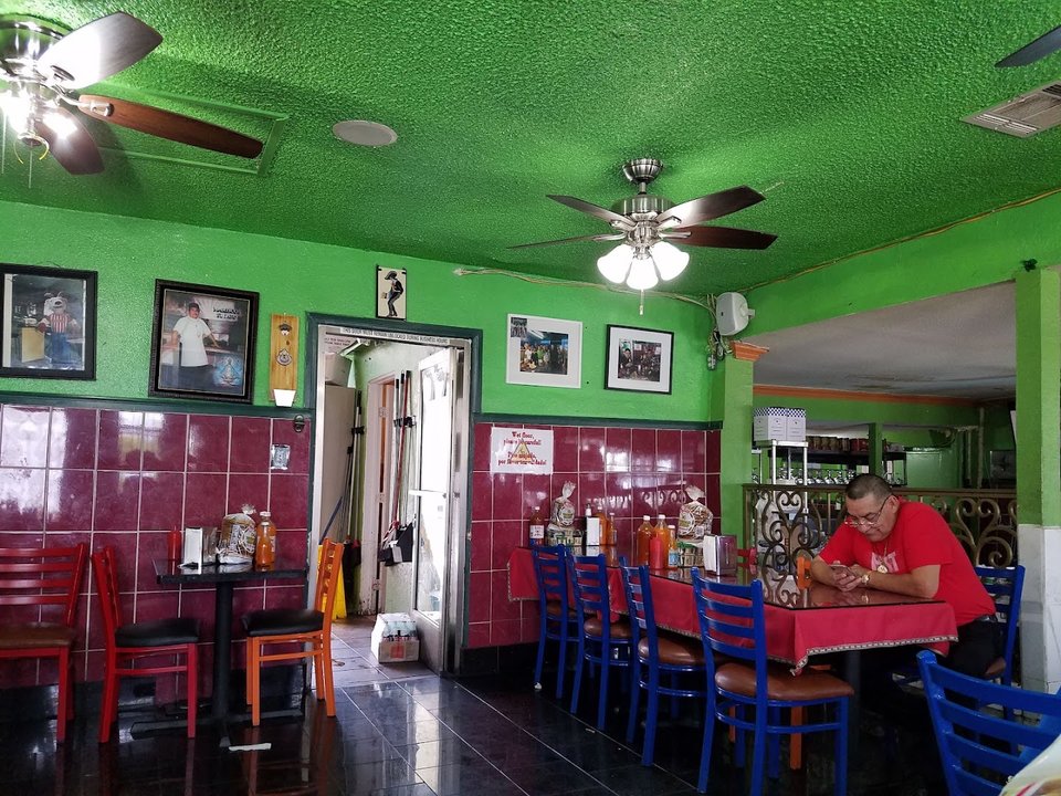 Fish tacos and tostadas on a busy counter.