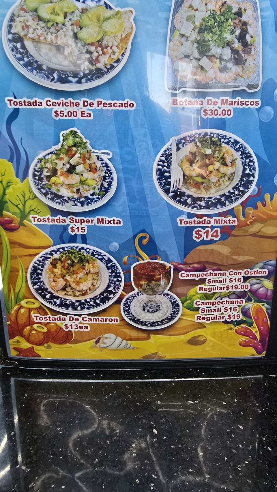Seafood menu with tacos and ceviche cups.